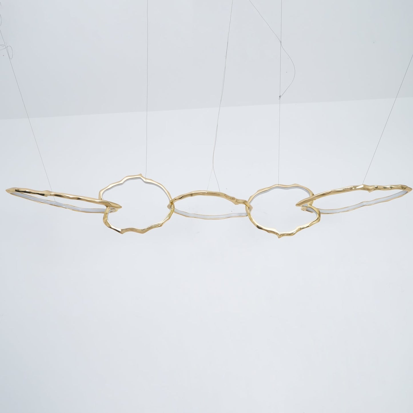 Elegant Brass Chandelier with Adjustable Arms and Ambient Lighting