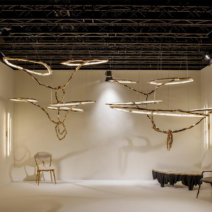 Elegant Brass Chandelier with Adjustable Arms and Ambient Lighting